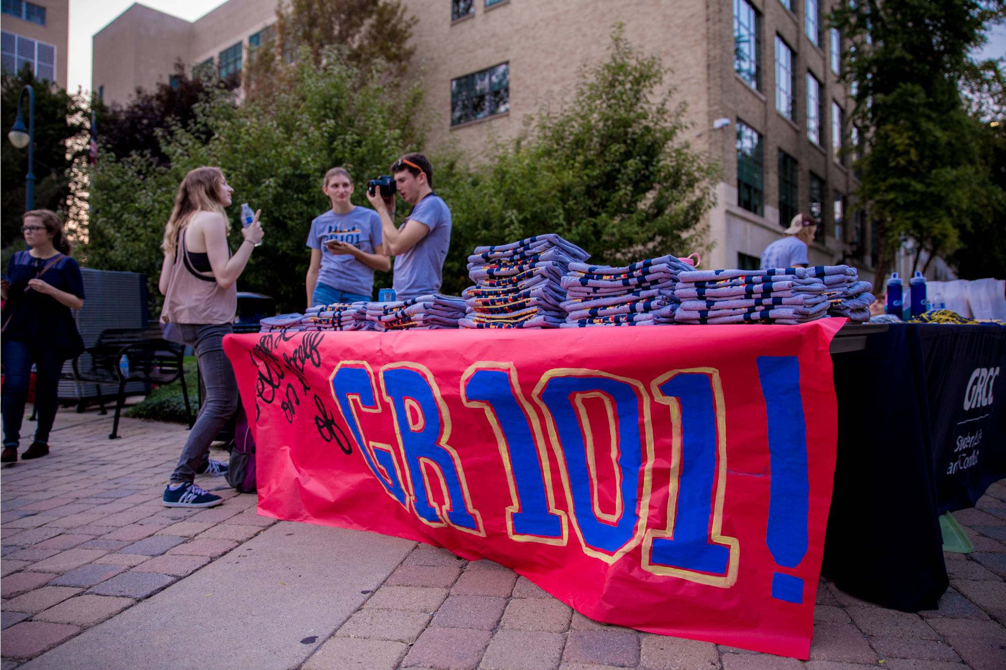 Table with t shirts and a banner displaying "GR 101"
